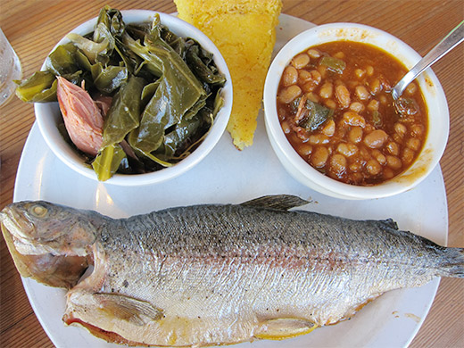 Smoked Whole Ruby Trout ($12) served with side of Collard Greens, BBQ Beans and a wedge of corn bread.